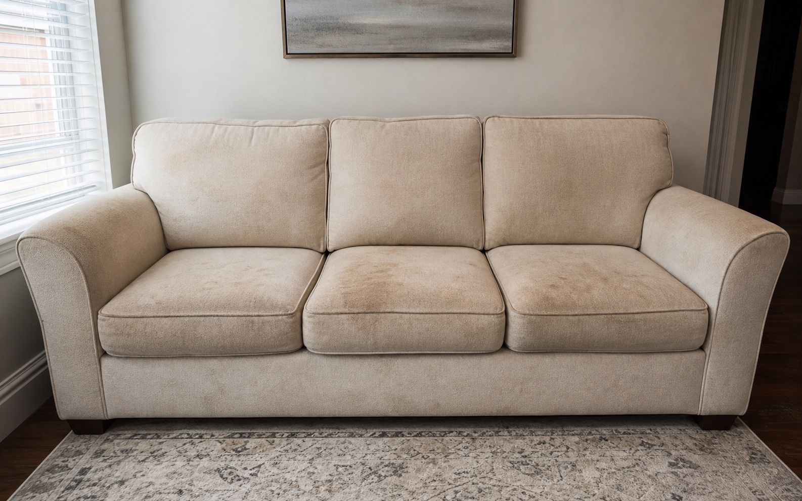 Stained light beige sofa before professional cleaning